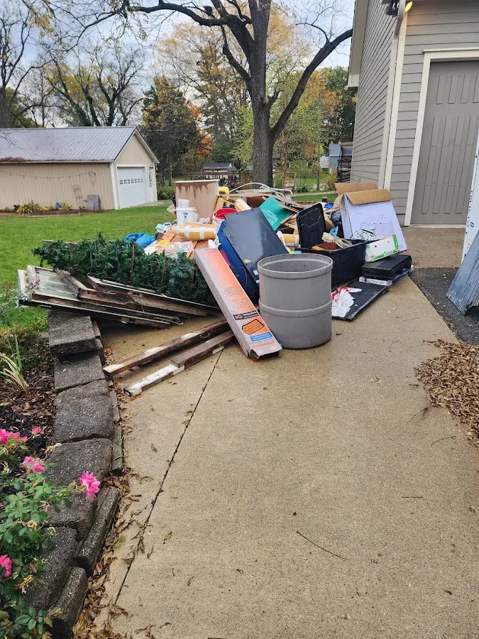 Dumpster being loaded with debris for Roofing Dumpster Rental in Pine Hills